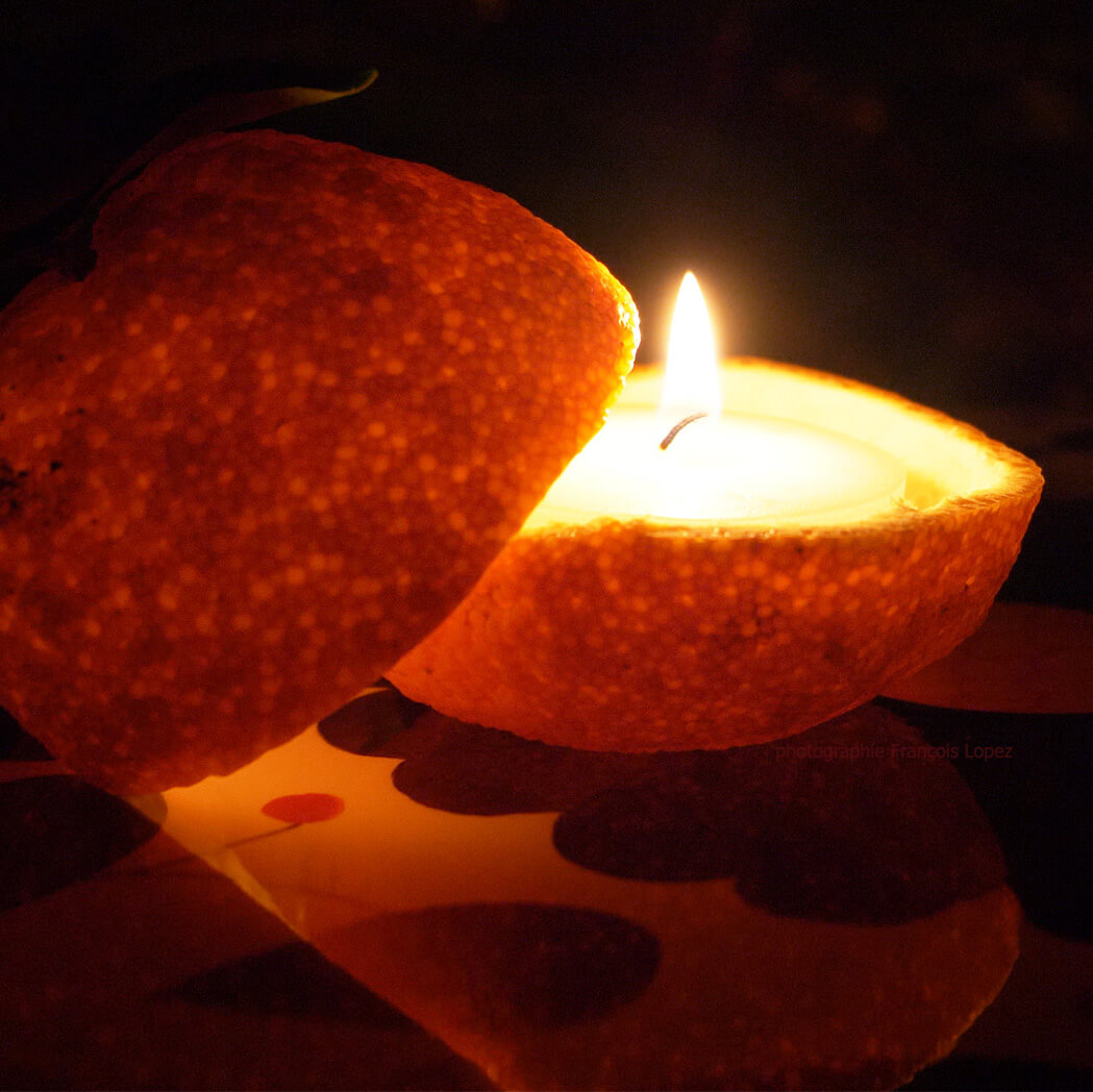 burning candle in a clementine